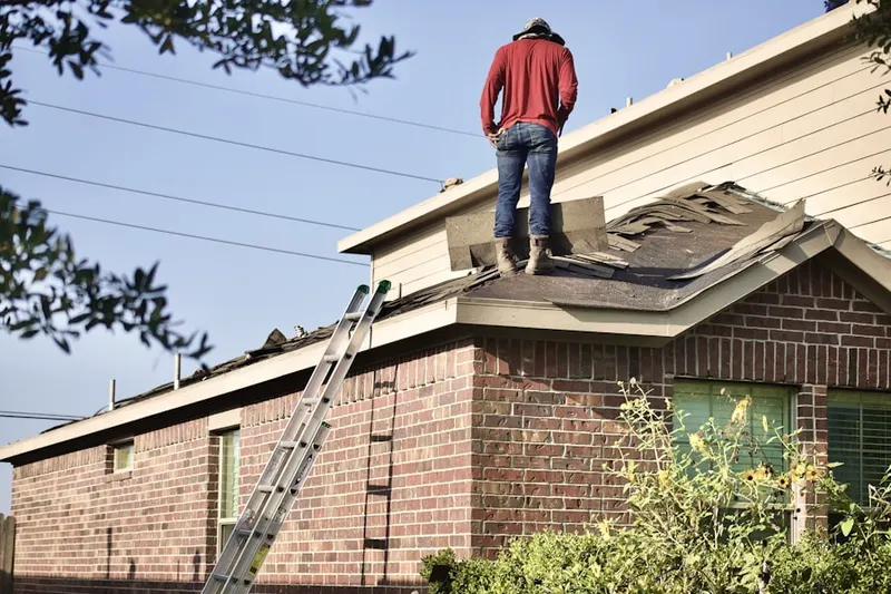 Professional roofer working on a residential roof in Strangford
